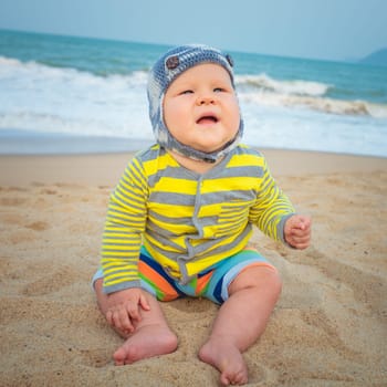 Cute baby sitting on a sand