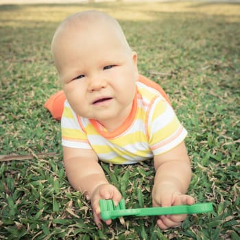Cute baby playing on a grass