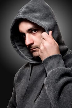 Young angry gangster with the hood on his head