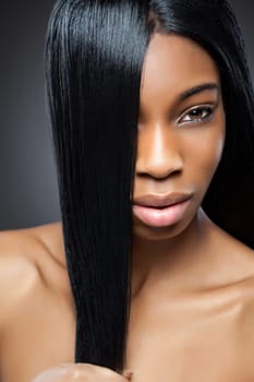 Beautiful young black woman with long straight hair