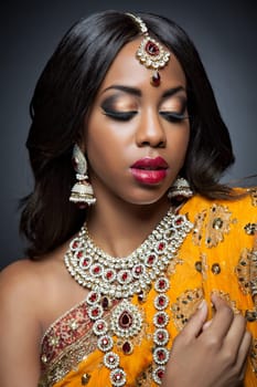 Young Indian woman dressed in traditional clothing with bridal makeup and jewelry