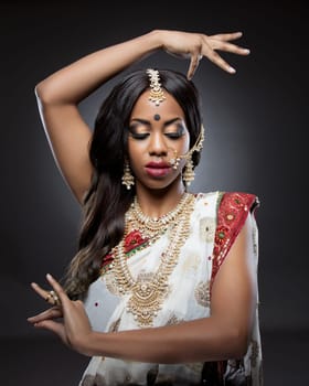 Young Indian woman dressed in traditional clothing with bridal makeup and jewelry