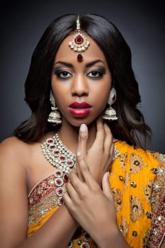 Young Indian woman dressed in traditional clothing with bridal makeup and jewelry