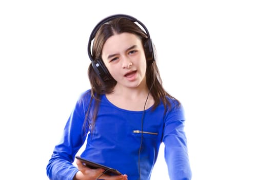 Smiling girl listening to music, holding a tablet pc in hands