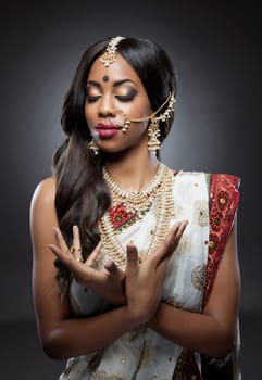 Young Indian woman dressed in traditional clothing with bridal makeup and jewelry