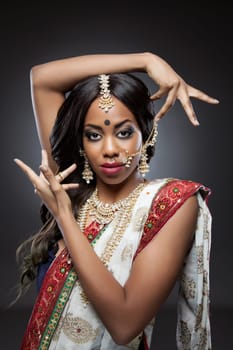 Young Indian woman dressed in traditional clothing with bridal makeup and jewelry