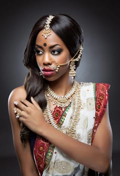 Young Indian woman dressed in traditional clothing with bridal makeup and jewelry