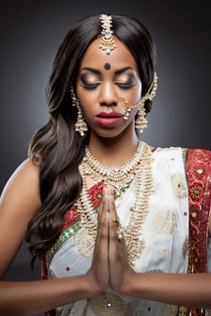 Young Indian woman dressed in traditional clothing with bridal makeup and jewelry