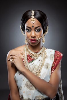 Young Indian woman dressed in traditional clothing with bridal makeup and jewelry