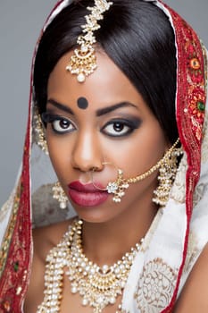 Young Indian woman dressed in traditional clothing with bridal makeup and jewelry