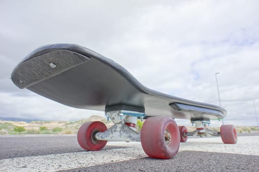 Hdr Picture Vintage Style Longboard Black Skateboard on an Empty Asphalt Desert Road