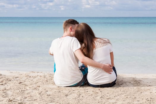 In love young couple on the beach in summer holiday relaxation togetherness love