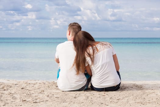 In love young couple on the beach in summer holiday relaxation togetherness love