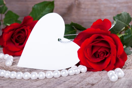 Empty Label in Heart Shape with Roses as Background
