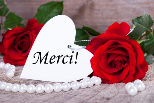 Background with Roses and Pearls and the French Word Merci which means Thanks