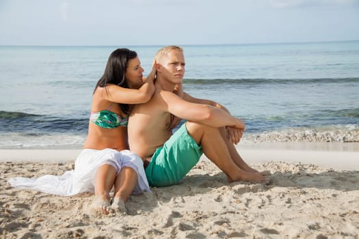 Young happy couple in love on the beach in summer holidays leisure rest recreation holiday sun