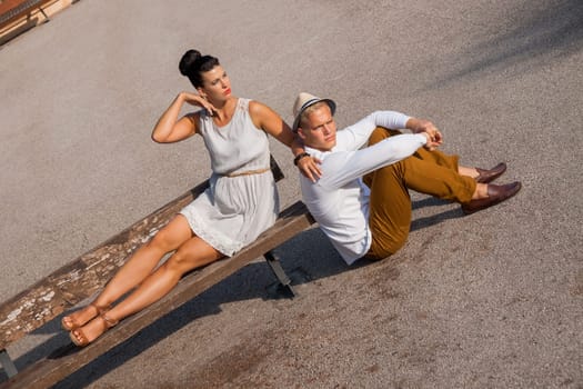 Young elegant couple with fashionable clothes in summer outdoor leisure park