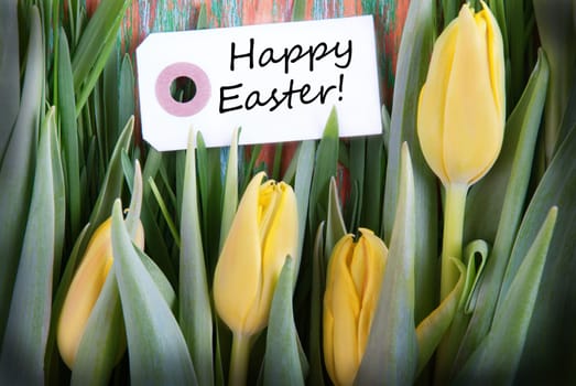 Easter Background with a Label with Easter Greetings and Yellow Tulips