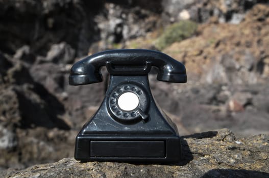 International Communications Vintage Telephone Toy on the Volcanic Rocks