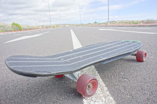 Hdr Picture Vintage Style Longboard Black Skateboard on an Empty Asphalt Desert Road
