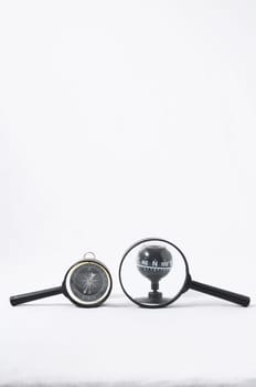 Orientation Concept Magnify Glass and Compass on a White Background