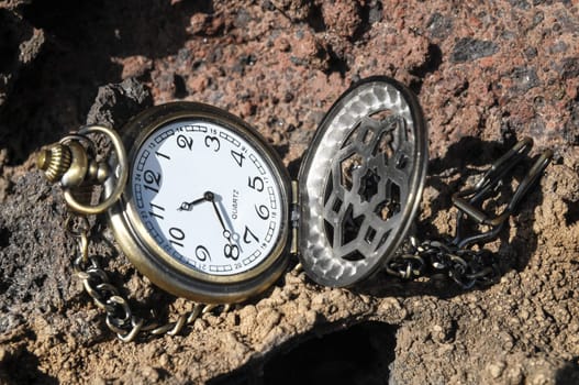 Time Concept Classic Vintage Pocket Clock on the Volcanic Rocks