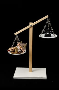 Money and Telephone on a Two Pan Balance