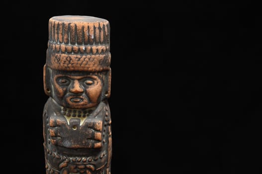One Ancient Mayan Statue on a Black Background