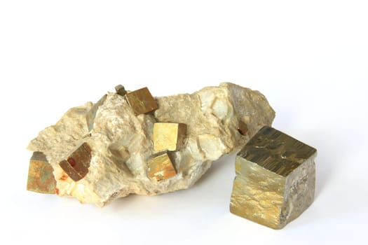 Pyrite crystals in the host rock and single cube-shaped crystal