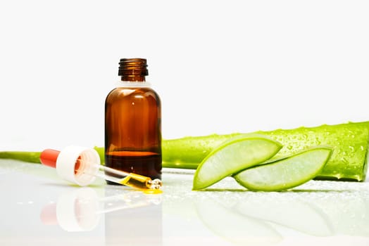 Woman's hand dropping a drop from a leaf of aloe vera in a bottle