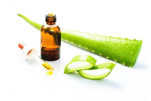 Woman's hand dropping a drop from a leaf of aloe vera in a bottle