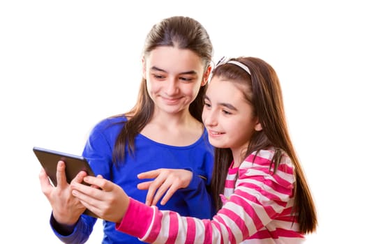 Happy teen girls with digital tablet  on white background.