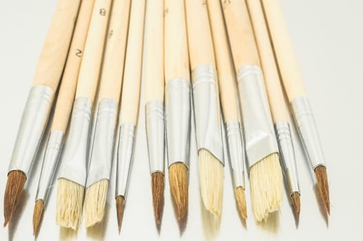 New Wooden Different Paintbrush Set Texture over a Colored Background