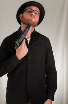 Black Dressed Young Man Holding a Pistol Gun