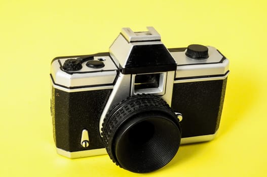 Classic 35mm Plastic Toy Photo Camera on a Colored Background