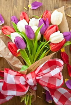 Colourful bouquet of tulips on rustic wood