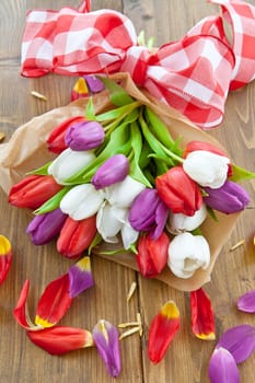 Colourful bouquet of tulips on rustic wood
