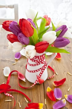 Colourful bouquet of tulips on rustic wood