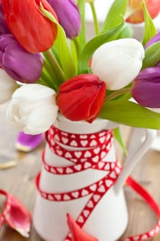 Colourful bouquet of tulips on rustic wood