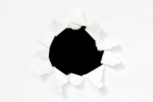Hole in a paper with black background inside