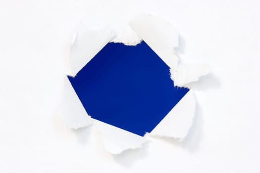 Hole in a paper with blue background inside