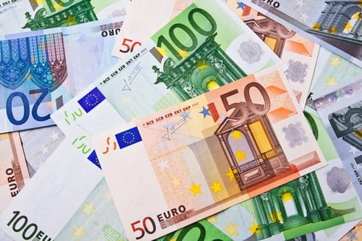 Many euro banknotes making european currency background