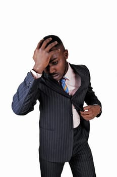 A black young man standing for white background with his hand on his head.looking desperate..