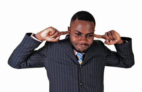 Young black businessman putting his fingers in his ears, dos not like.to hear..