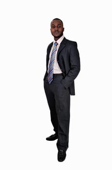 A young black business man standing in a suit and tie with his hands.in his pocket for white background..
