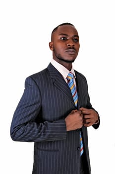 A young black business man standing in a suit and tie, with his hands.on his chest for white background..