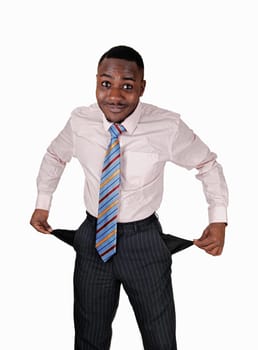 A black young man standing for white background turned his pockets.out to show he has no money..