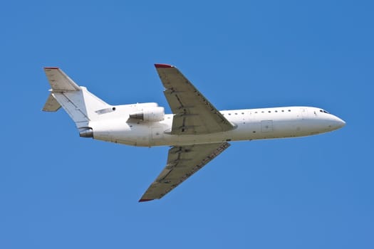 Beautiful white passenger airplane in blue sky