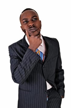 A young black business man standing in a suit and tie with his hand.on his chin and thinking hard, for white background..