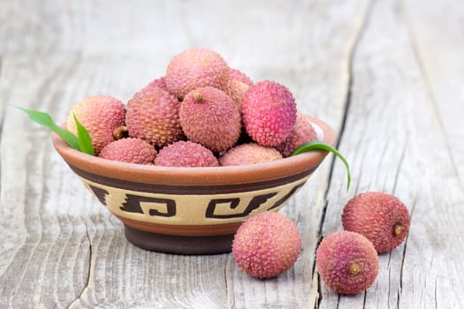 fresh lychees in a bowl  on wooden background